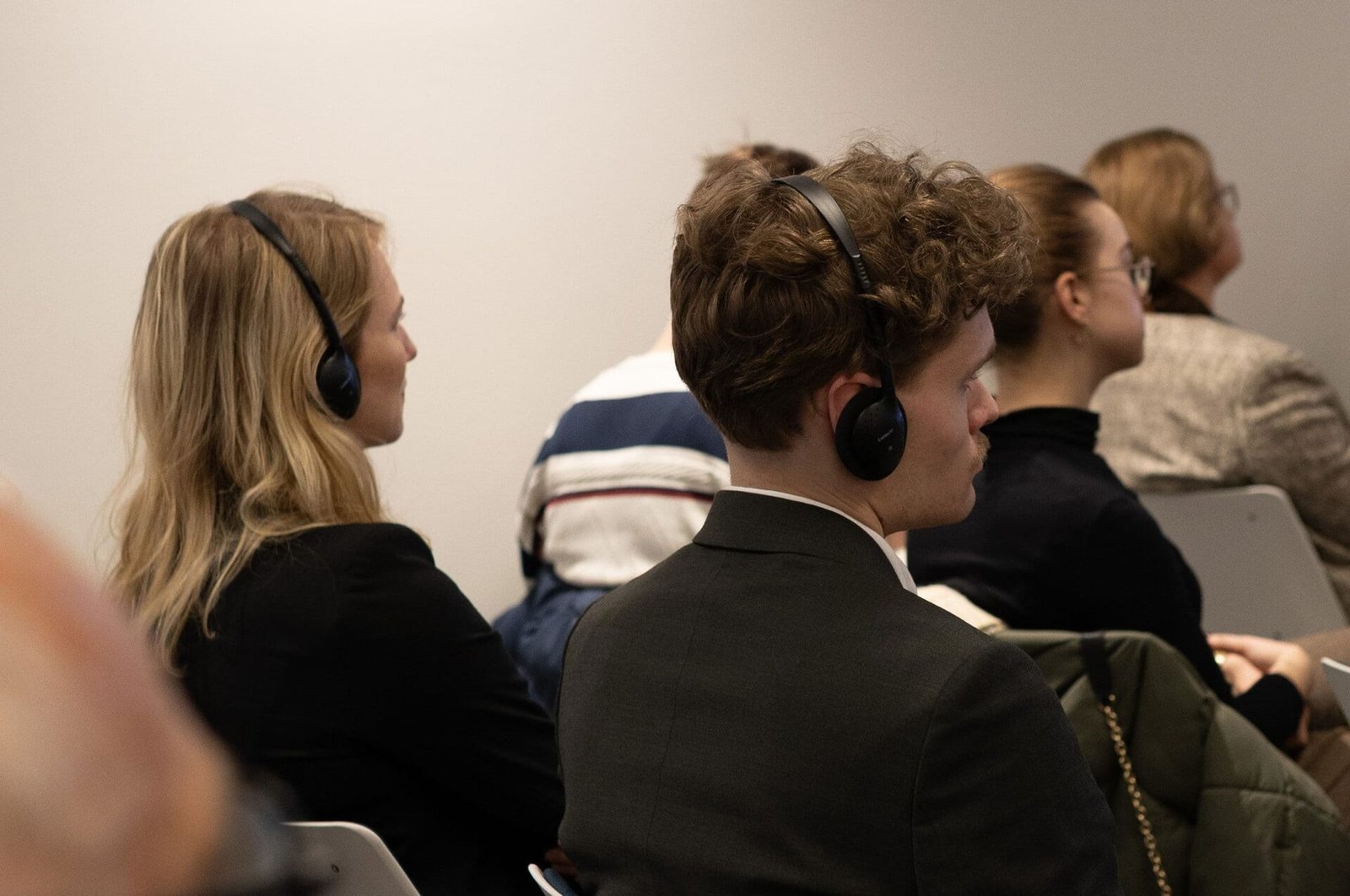 Audience in a FPF event listening with translation headphones on